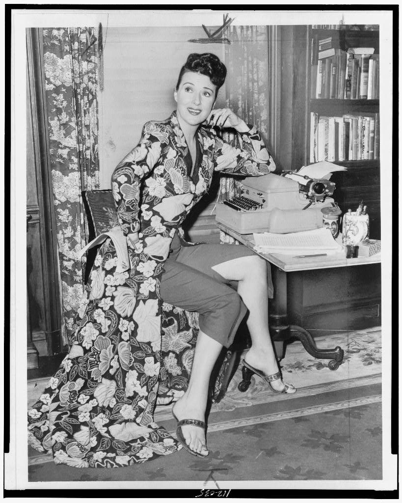 Palumbo, Fred, photographer. [Gypsy Rose Lee, full-length portrait, seated at a typewriter, facing slightly right/ World Telegram & Sun photo by Fred Palumbo]. 1956. Image. Retrieved from the Library of Congress, https://www.loc.gov/item/94511004/. (Accessed January 06, 2017.)